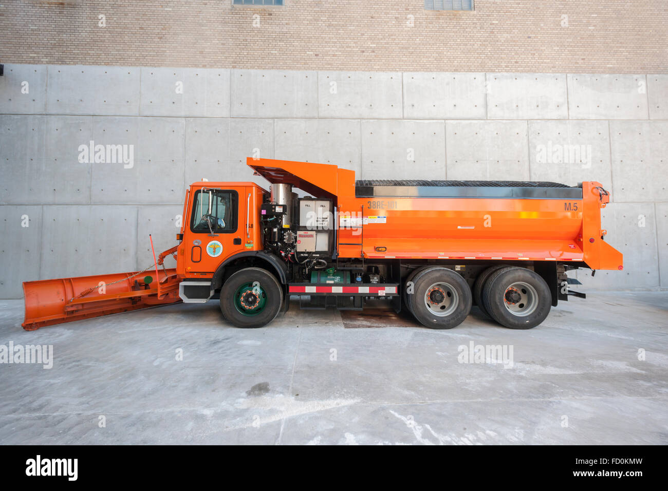 A salt spreader equipped with a plow awaits this weekends winter snowstorm at the New York City Dept. of Sanitation Salt Shed Thursday, January 21, 2016. The city is expecting blizzard conditions with gale force winds with up to 12 inches of snow starting Saturday in Sunday.   (© Richard B. Levine) Stock Photo