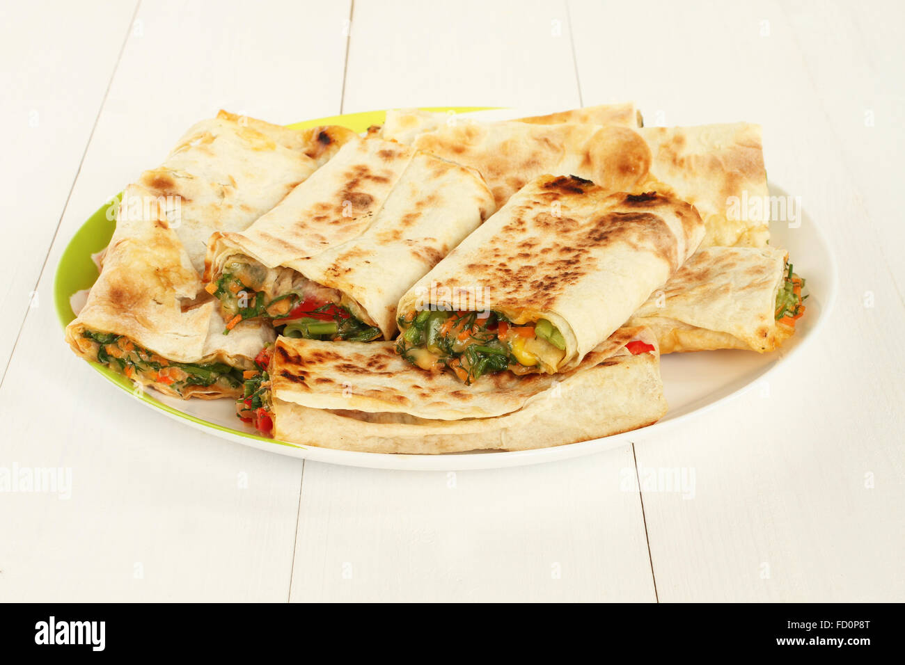 Roasted rolls of bread lavash filled with red sweet paprika, herbs and cheese Stock Photo Alamy