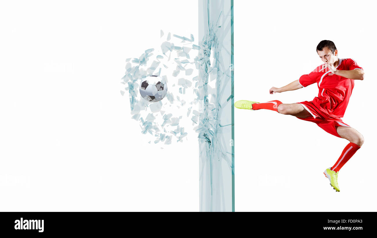 Football player kicking ball in jump and breaking glass Stock Photo Alamy