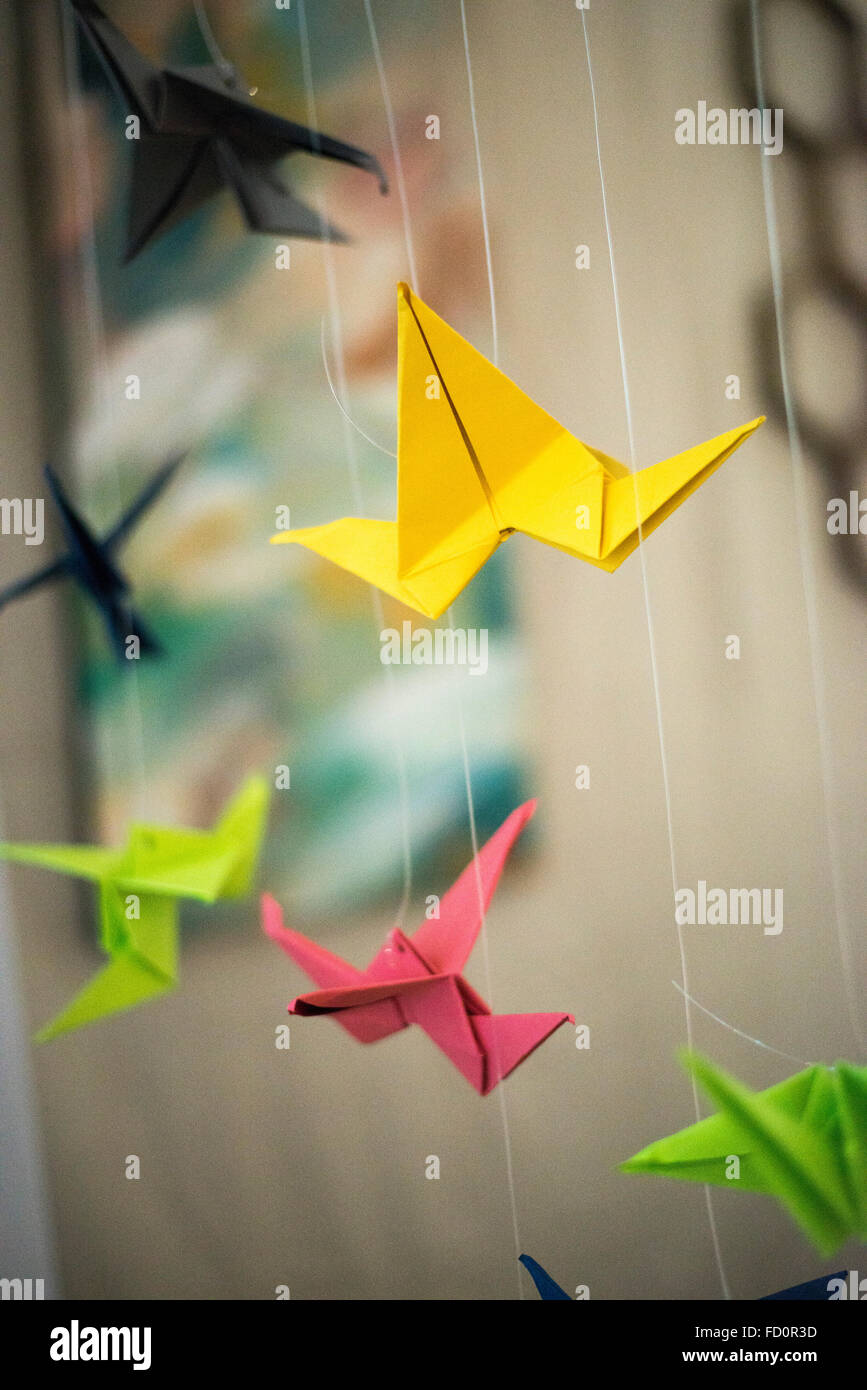 Colorful paper Origami birds in flight Stock Photo