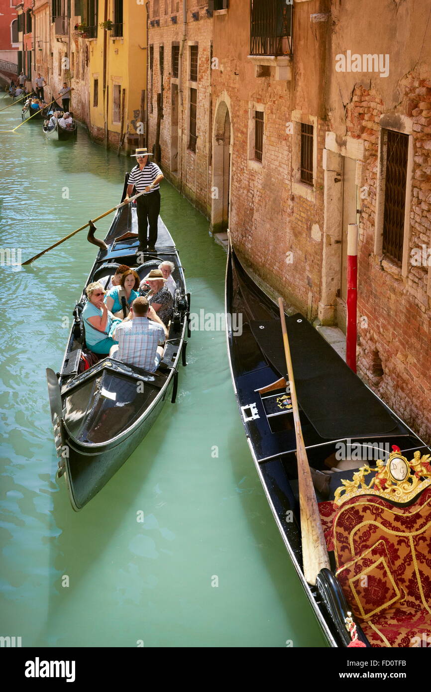 Venice, gondola with tourists, Italy Stock Photo