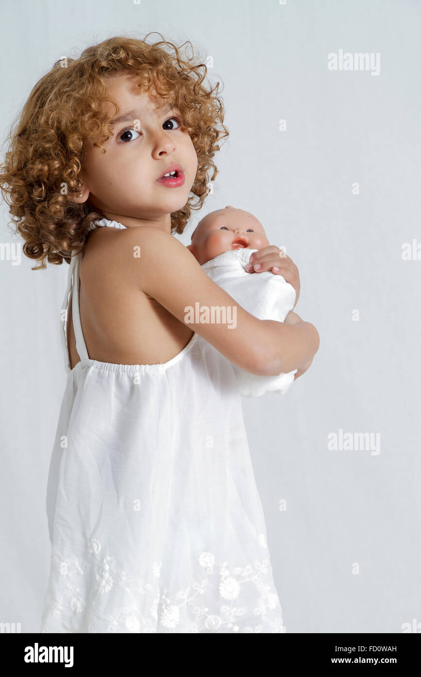 little girl holding doll