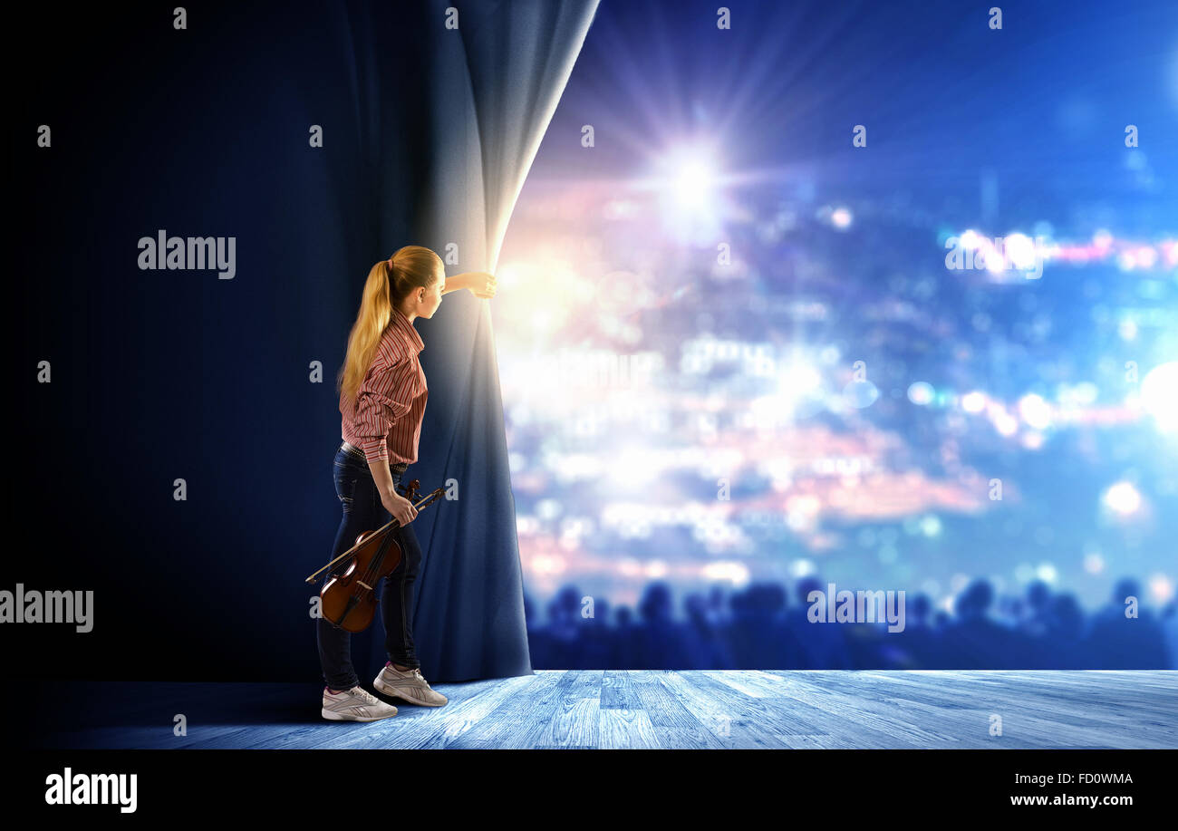 Young girl with violin on stage opening curtain Stock Photo - Alamy