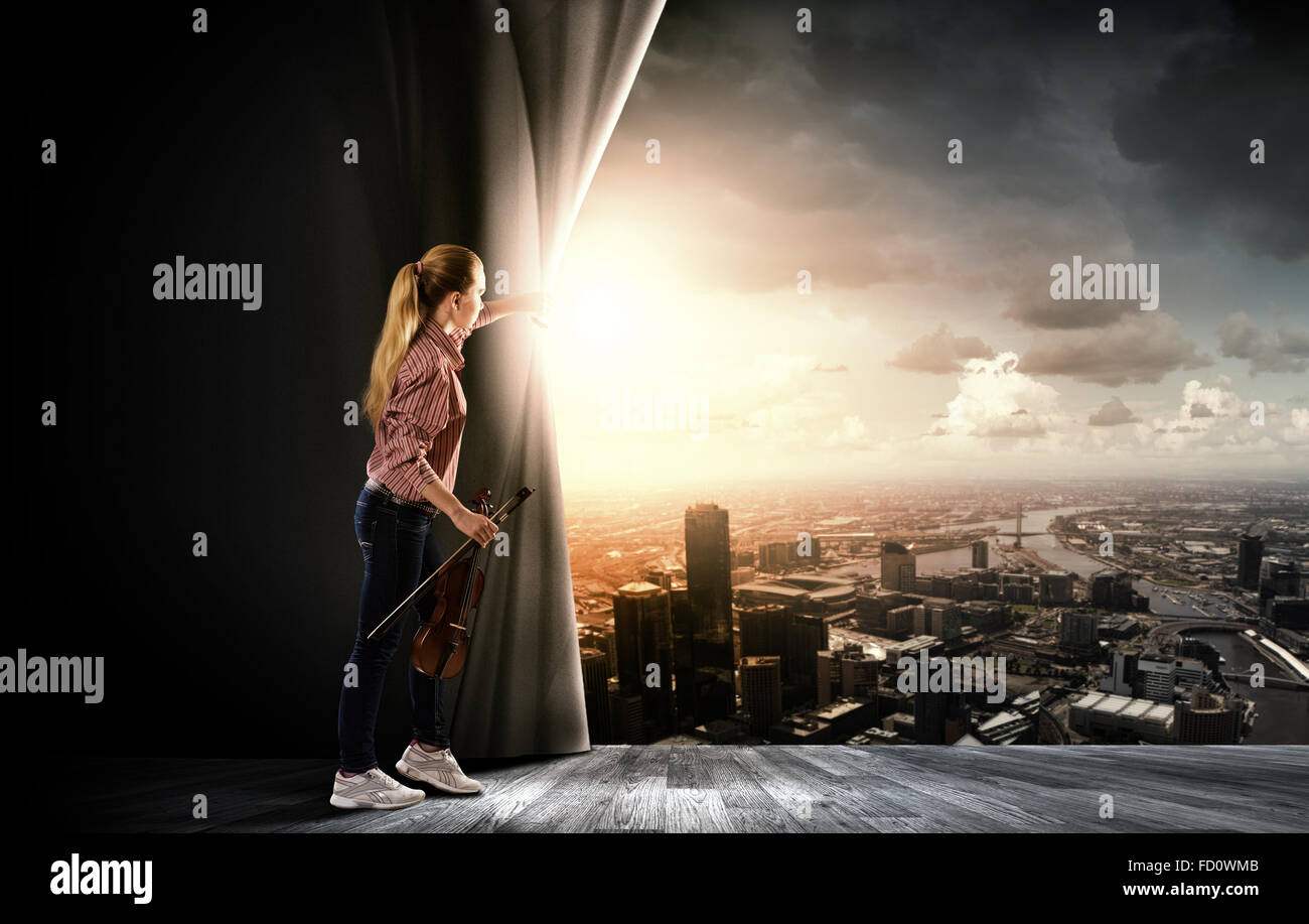 Young girl with violin on stage opening curtain Stock Photo - Alamy