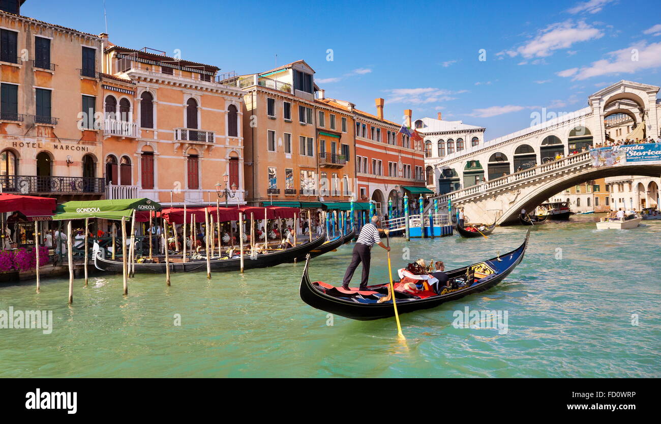 Venice - Grand Canal, tourists in gondola exploring Venice, Italy Stock Photo