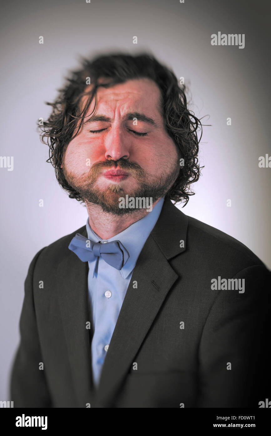 Bearded man holds his breath in anticipation and is turning blue Stock