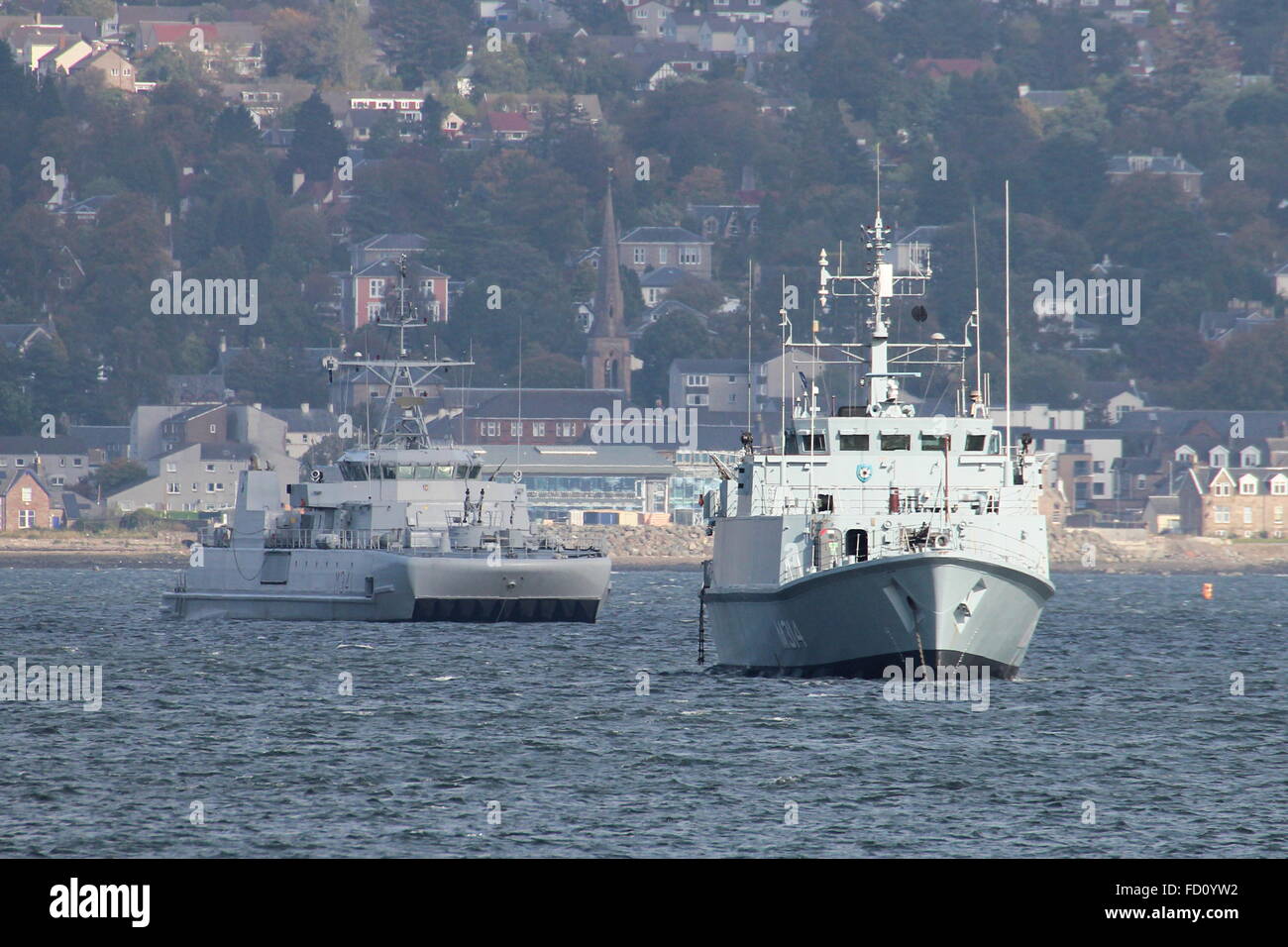 KNM Karmoy (left) and ENS Sakala (right), sit at anchor off Greenock Esplanade shortly after arriving for Joint Warrior 14-2 Stock Photo