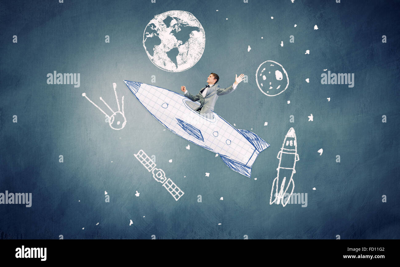 Young businessman flying in sky on drawn rocket Stock Photo - Alamy