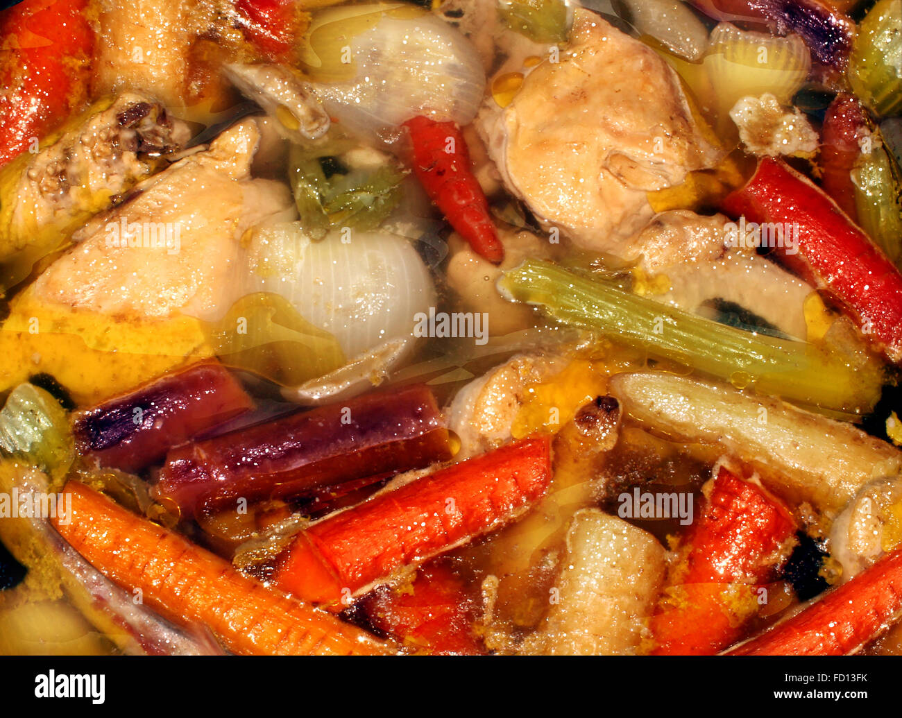 Rustic soup and healthy eating real food background made from scratch as a slow cooking hearty stew made of fresh chicken and market garden whole natural vegetables. Stock Photo
