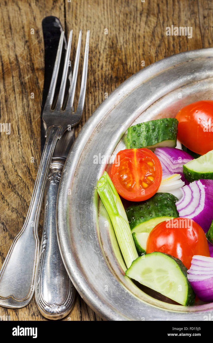Fresh vegetables in a silver flatware on old wooden table. Selective focus Stock Photo