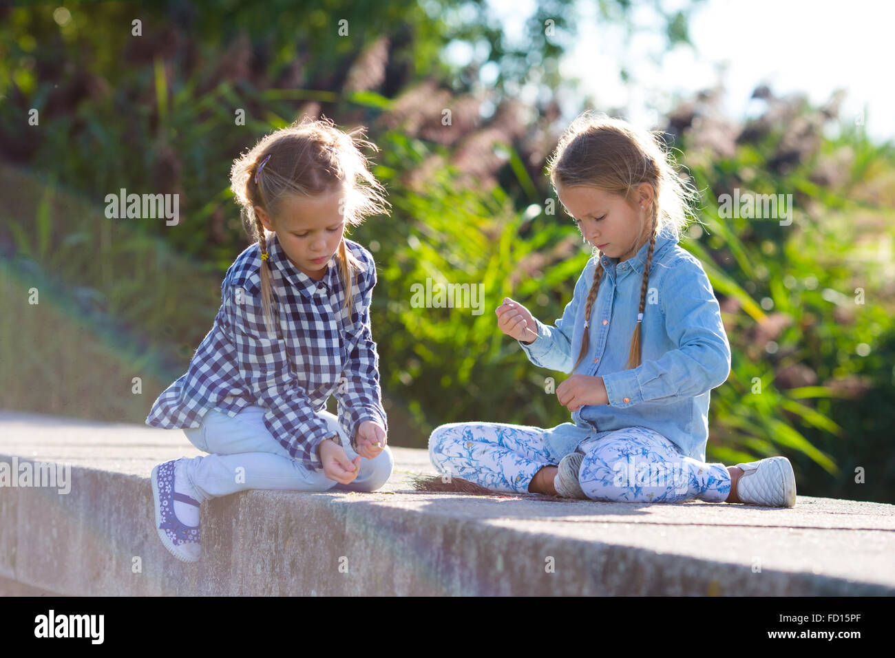 Little adorable girls at warm sunny autumn day outdoors Stock Photo - Alamy