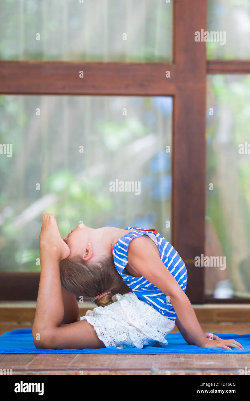 Little girl doing yoga exercise on terrace outdoors Stock Photo - Alamy