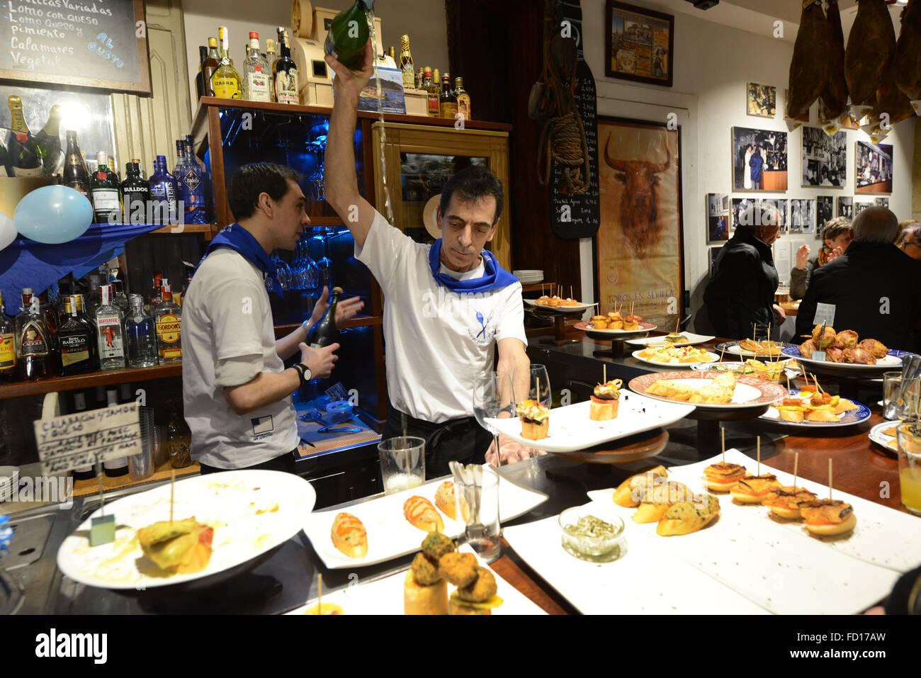 A Basque barman pouring traditional white wine called Txakoli in a traditional way. Stock Photo