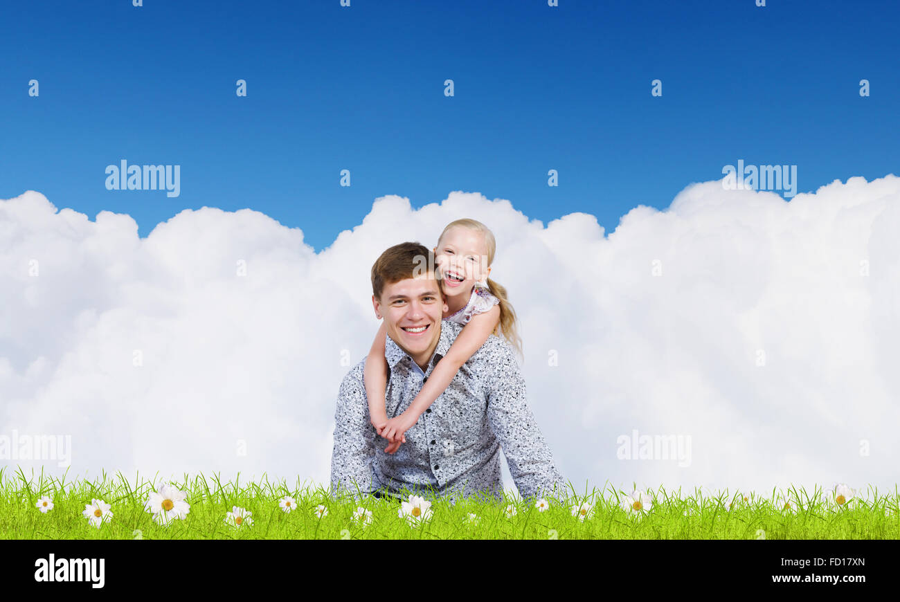 Happy family of father and daughter sitting on grass Stock Photo - Alamy