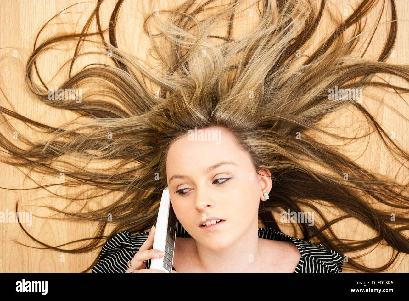 Head And Shoulders Blonde Teenage Blue Eyed Girl Laying On Wood