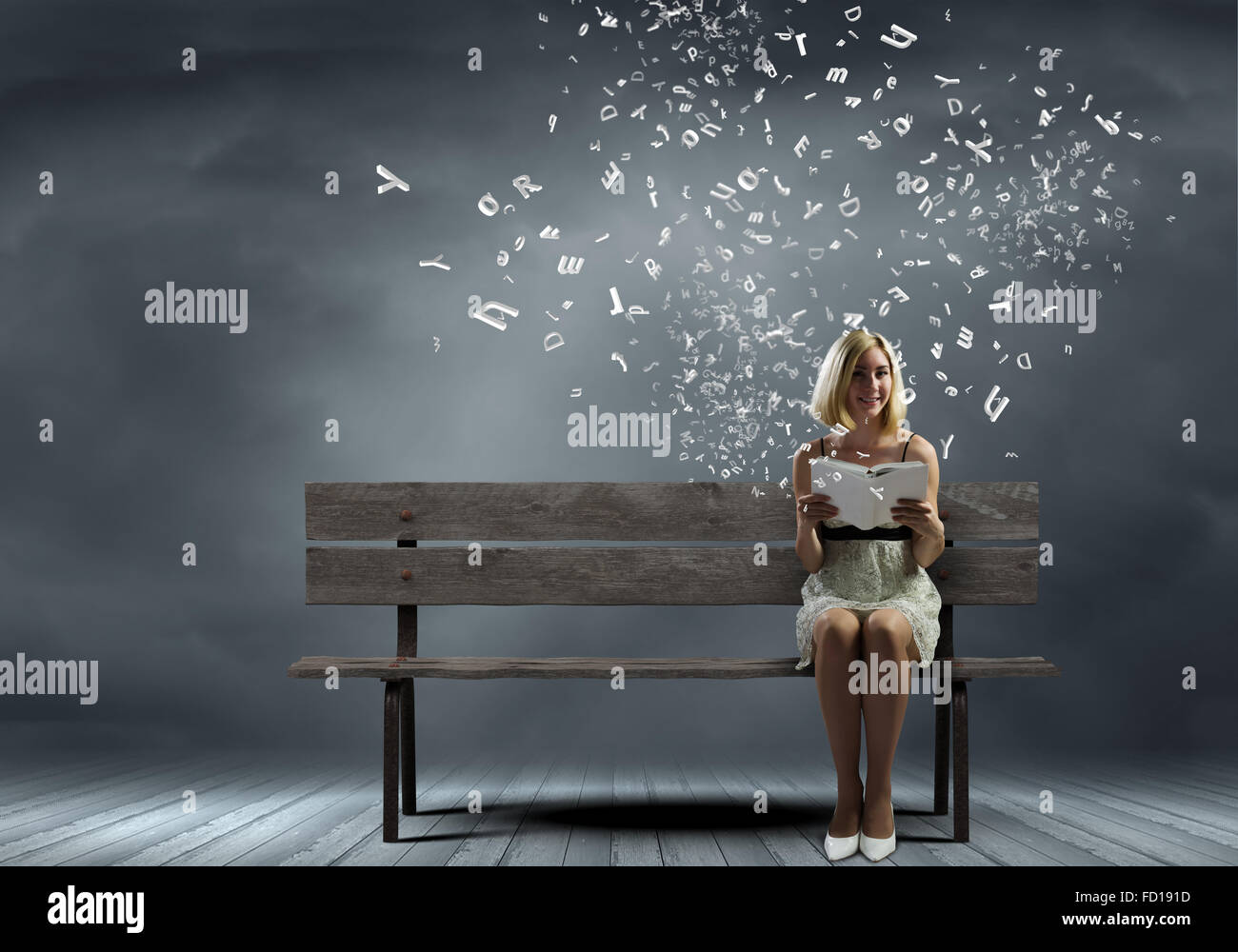 Young pretty woman sitting on bench and reading book Stock Photo - Alamy