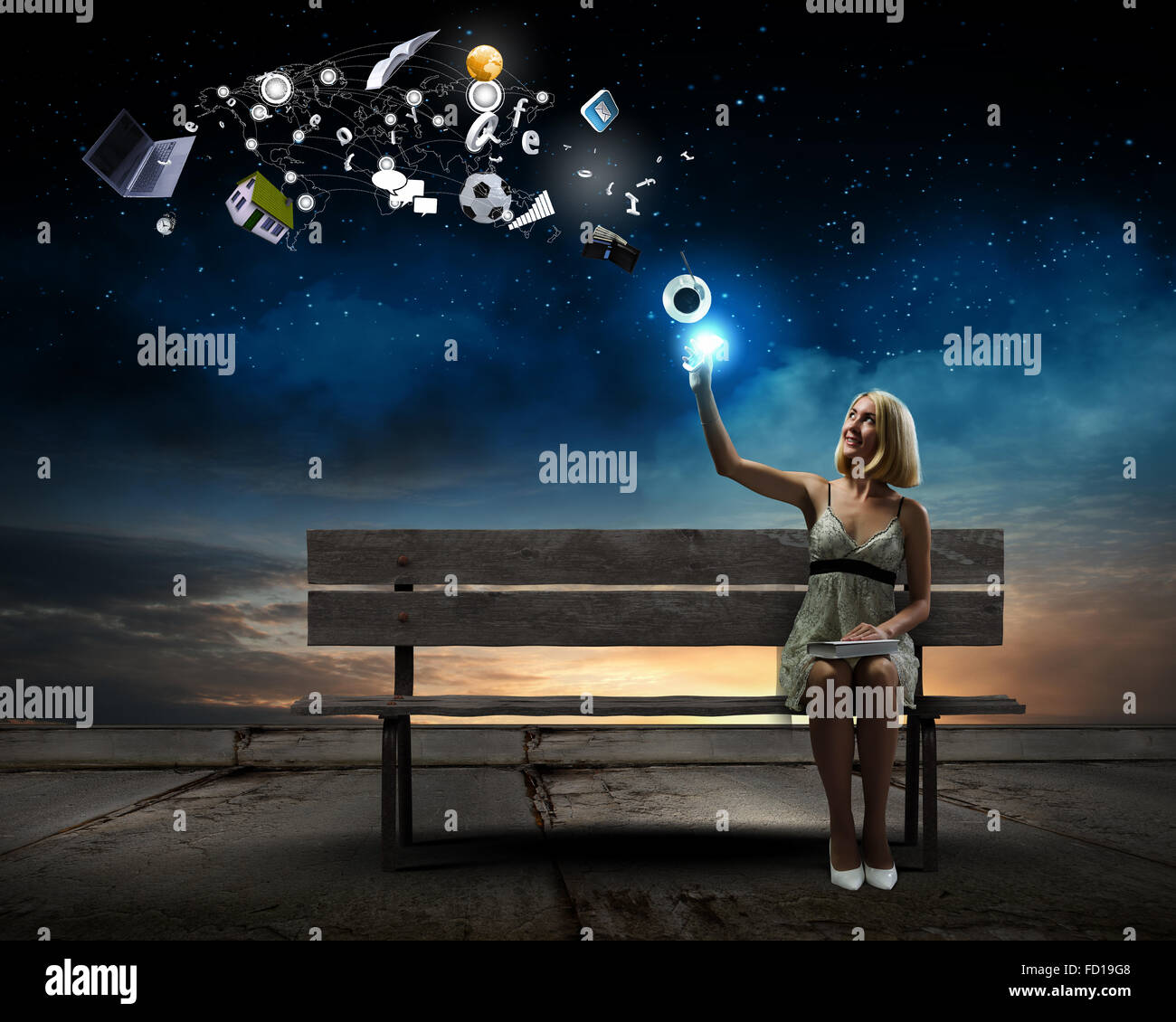 Young pretty woman sitting on bench and reading book Stock Photo - Alamy