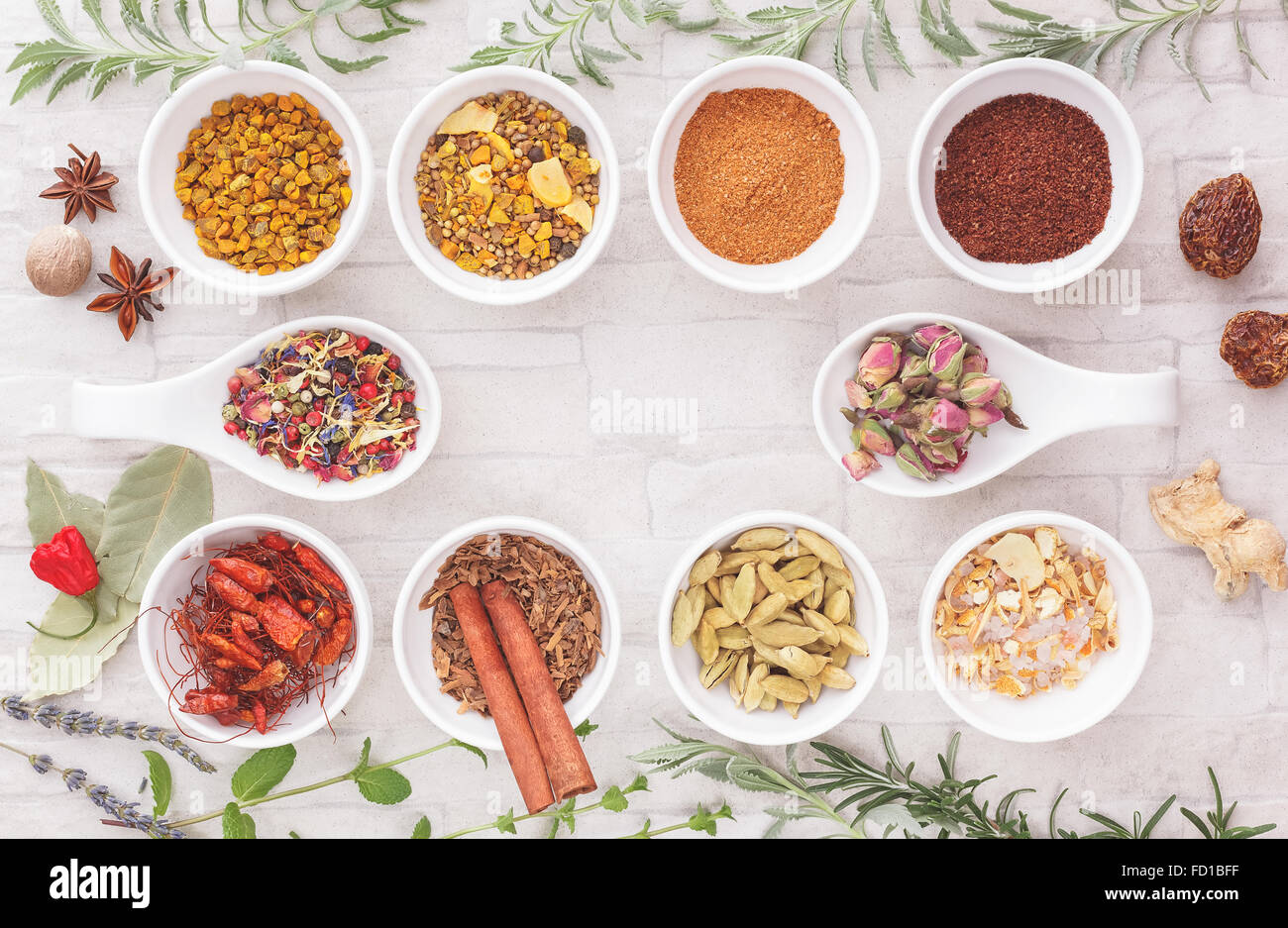 Assorted spices and herbs. An arrangement of spices and herbs on rustic background. Stock Photo