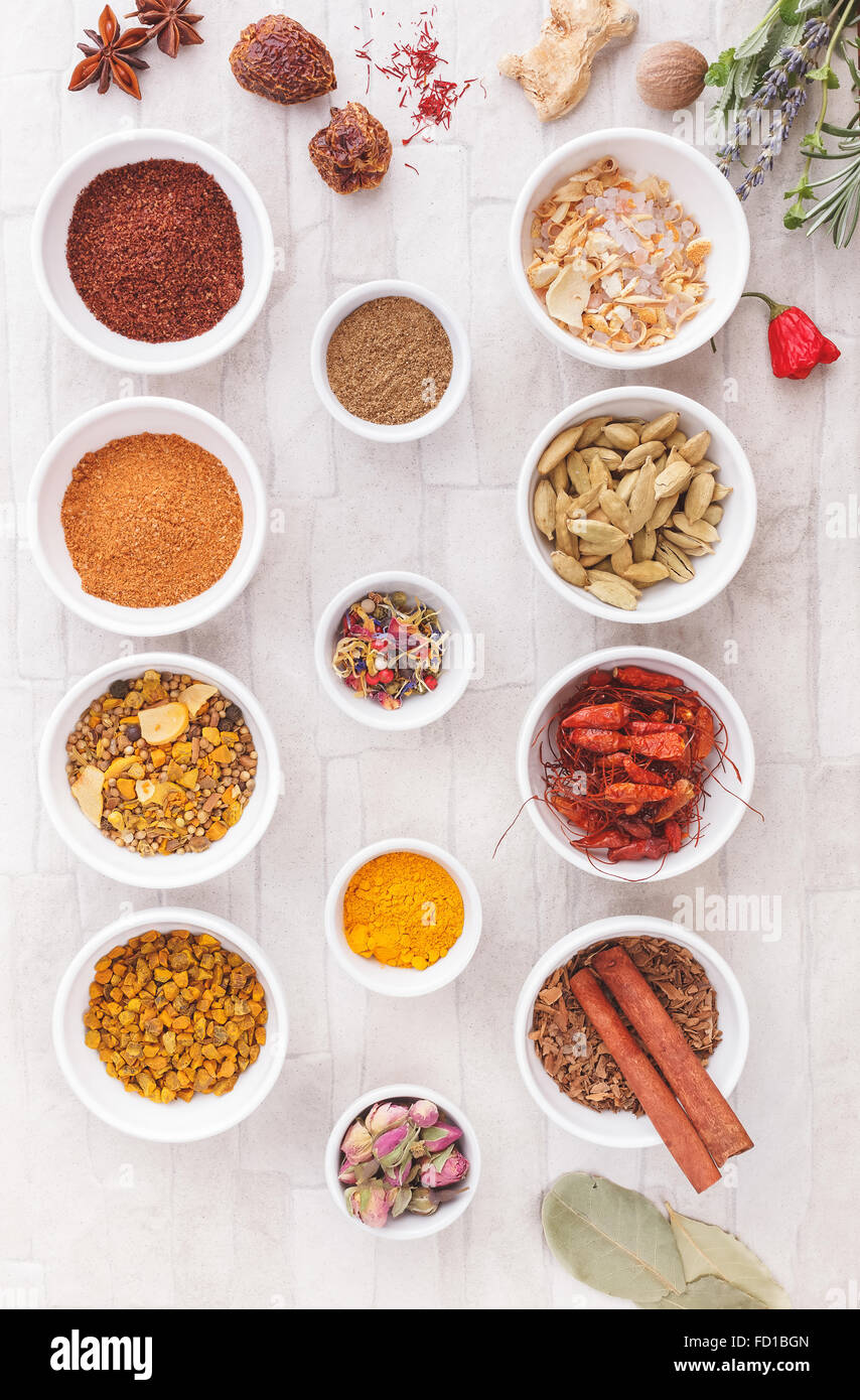 Various spices, dried and fresh herbs on table. An arrangement of spices and herbs over rustic background Stock Photo