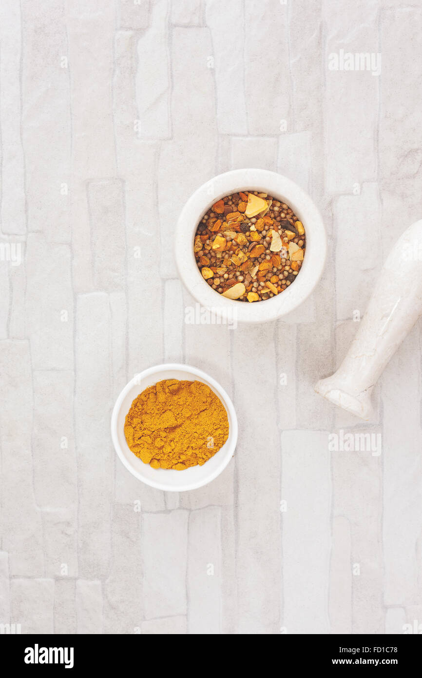 Curry spices.Curry in and beside a mortar. Top view, blank space, vintage toned image. Natural light Stock Photo