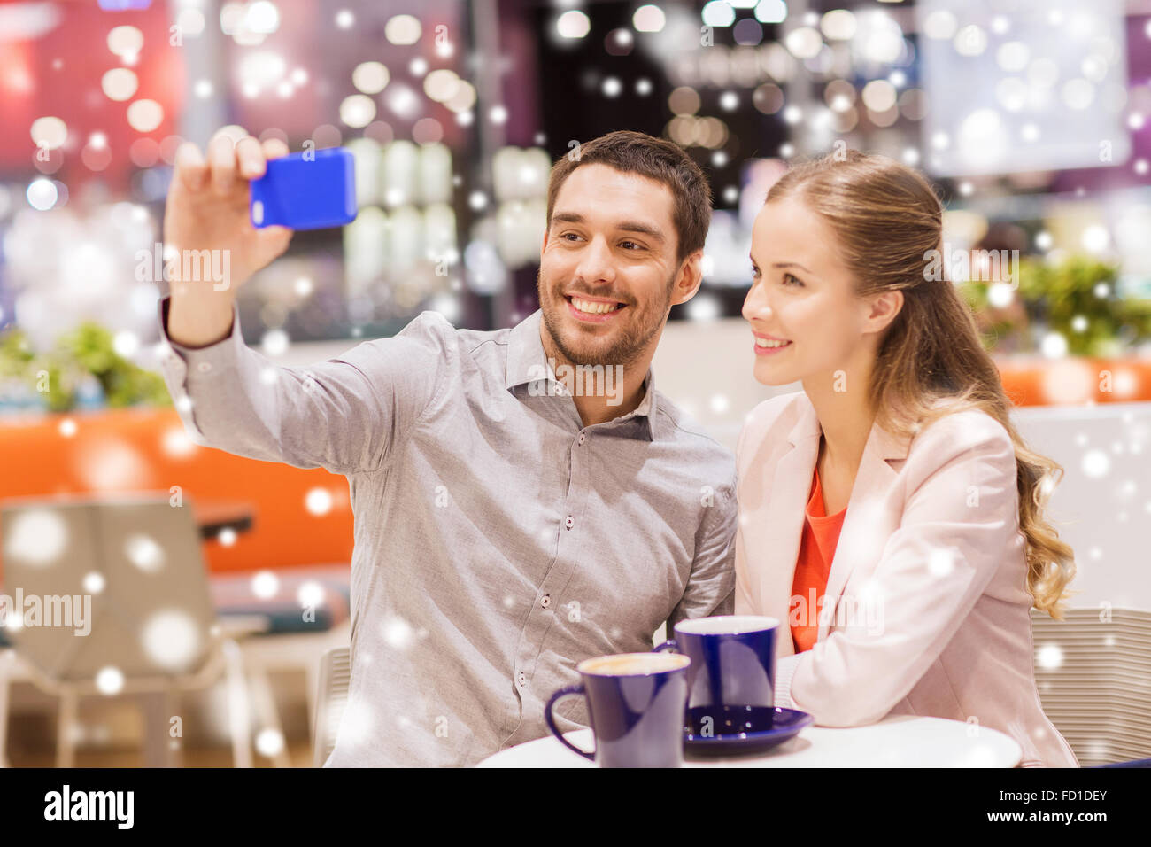 happy couple with smartphone taking selfie in mall Stock Photo - Alamy