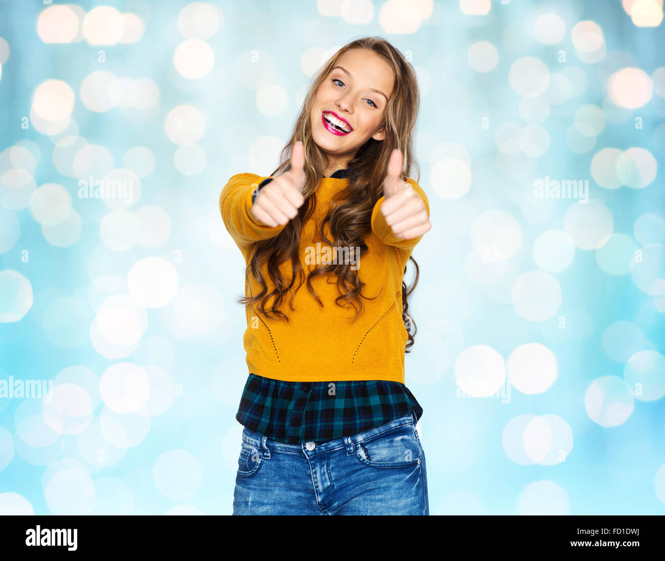 happy young woman or teen girl showing thumbs up Stock Photo - Alamy