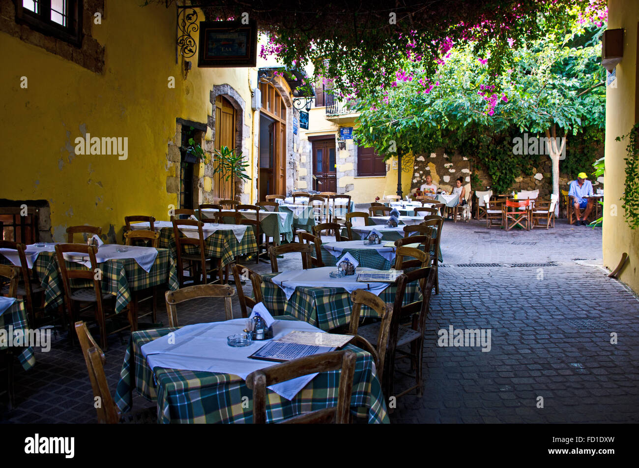 Old town Chania narrow street with restaurants, island Crete, Greece Stock Photo