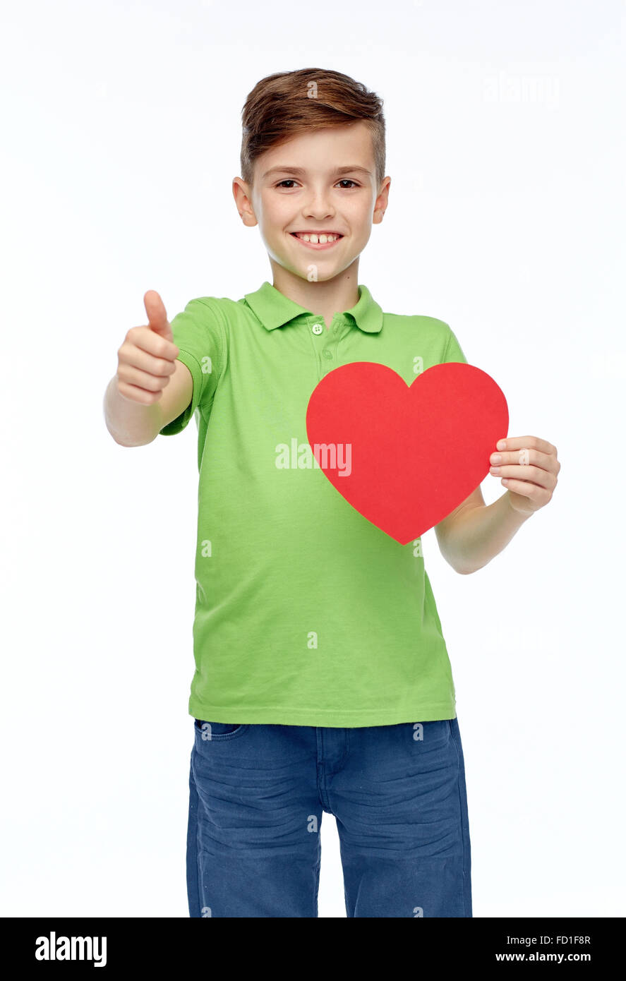 happy boy showing red heart shape and thumbs up Stock Photo - Alamy