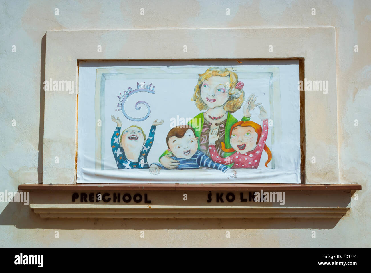 PRAGUE, CZECH REPUBLIC - AUGUST 28, 2015: Streetart: the woman with three children painted on the wall of the school. Vysehrad Stock Photo