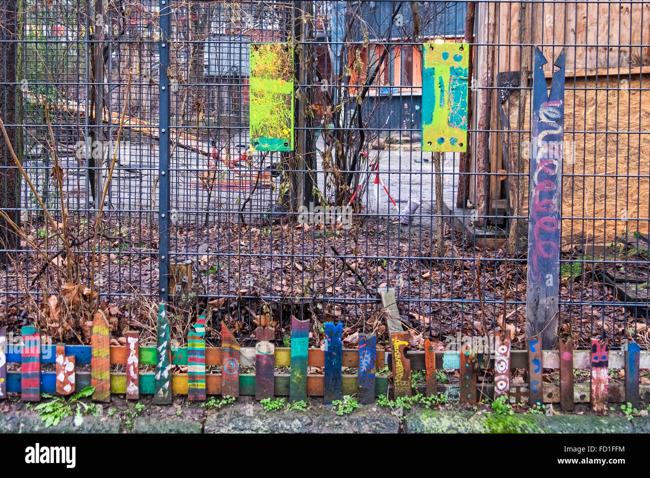 Berlin Kolle 37 spielplatz, Chikdren's playground with colourful hand painted decorated fence Stock Photo