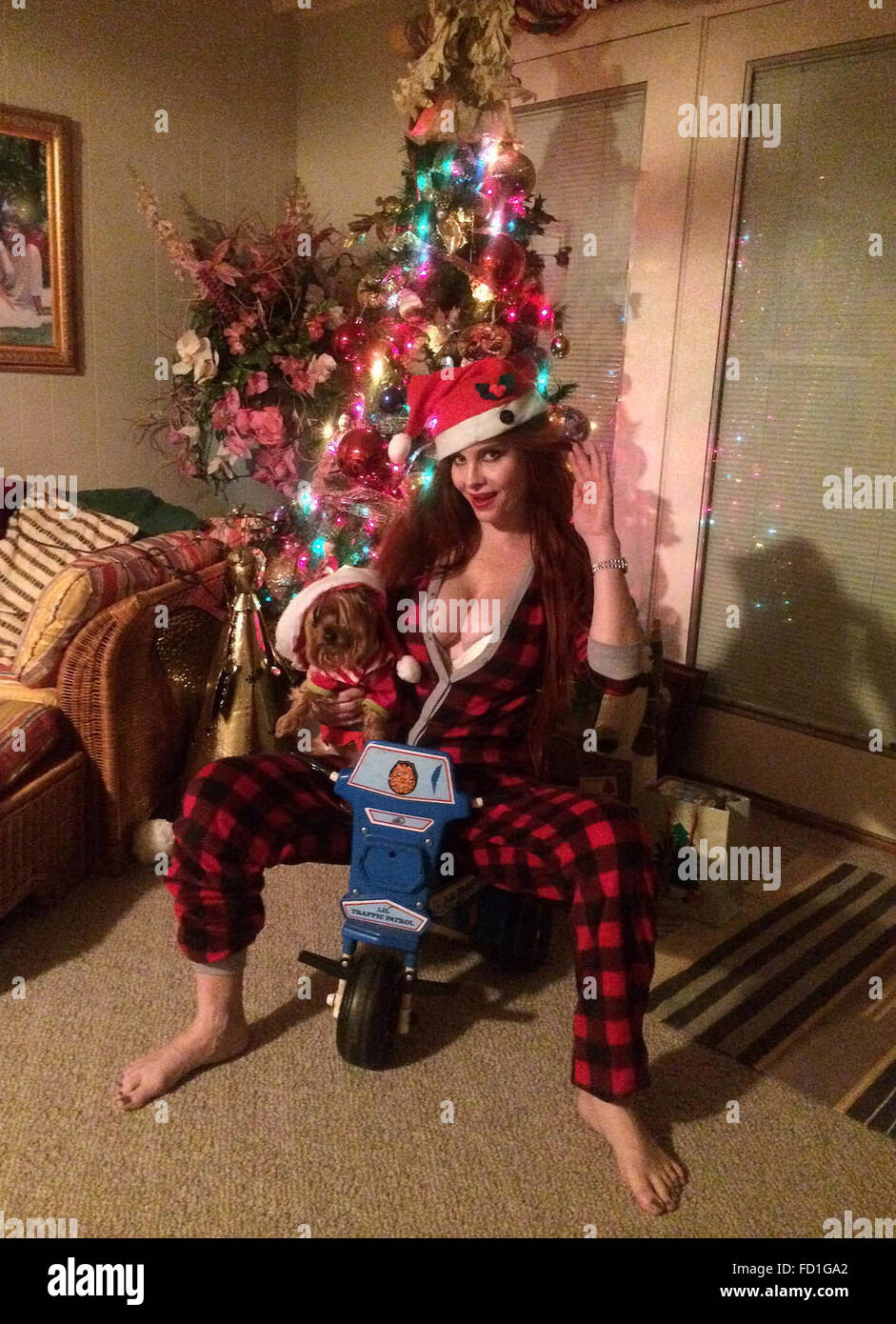 Phoebe Price and her dog Henry pose for pictures on Christmas Day morning at her home