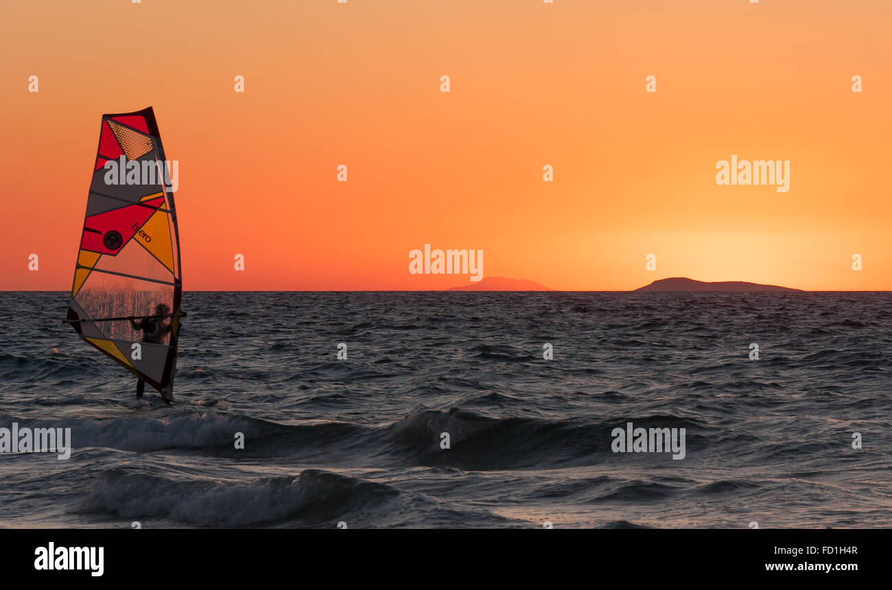 windsurfer on Aegean sea as sun sets Stock Photo