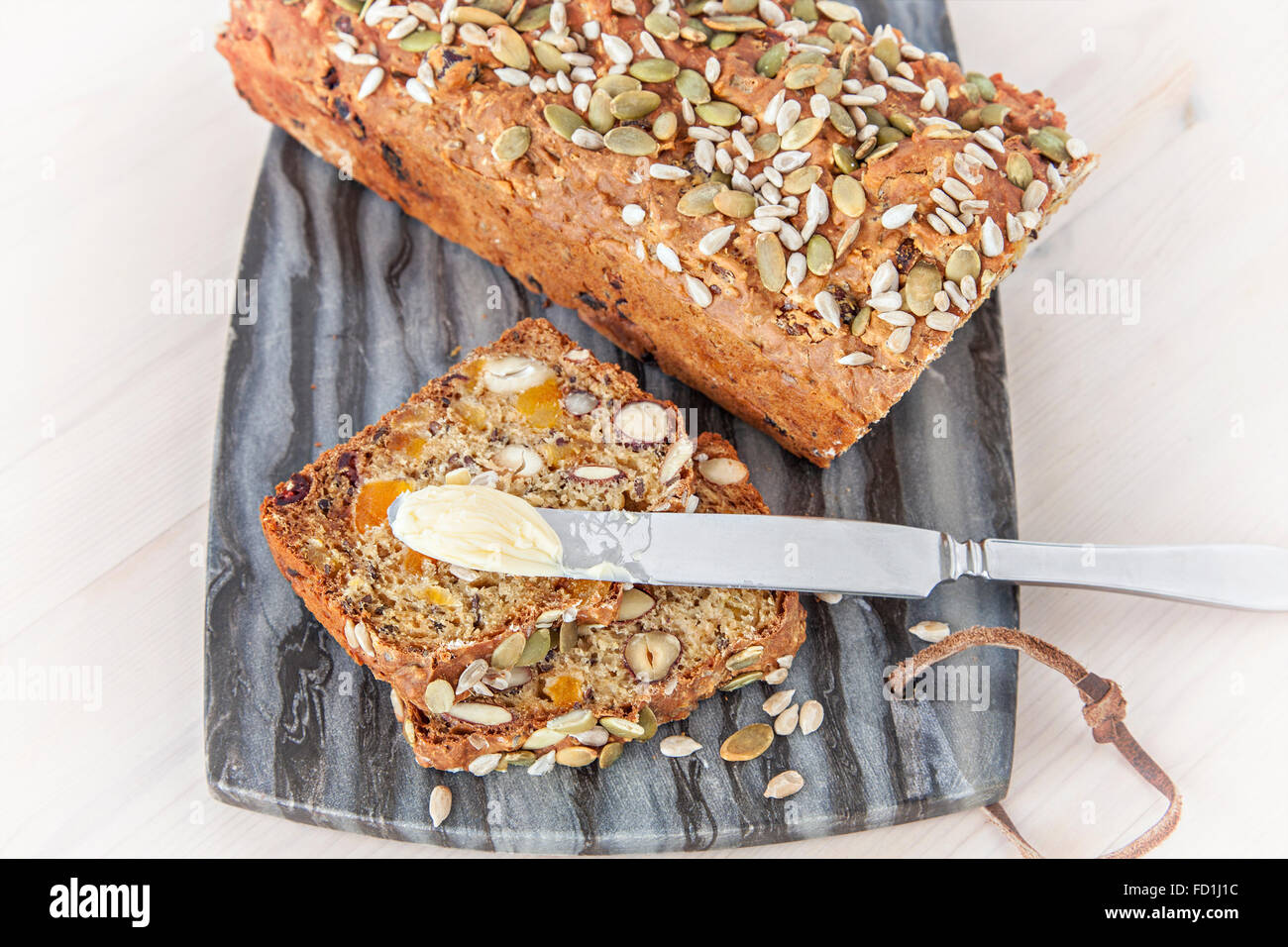 Image of delicious homemade spelt bread on a marble board. Stock Photo