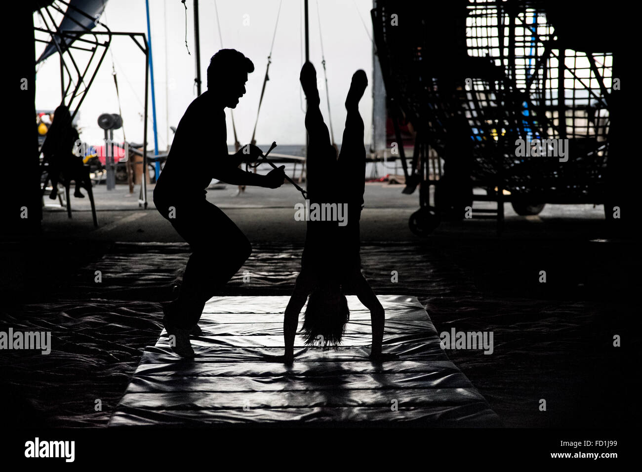 A young female acrobat, a member of the old circus family Fuentes Gasca from Mexico, performs a salto during the morning lessons in Circus Renato, in San Salvador, El Salvador. Stock Photo