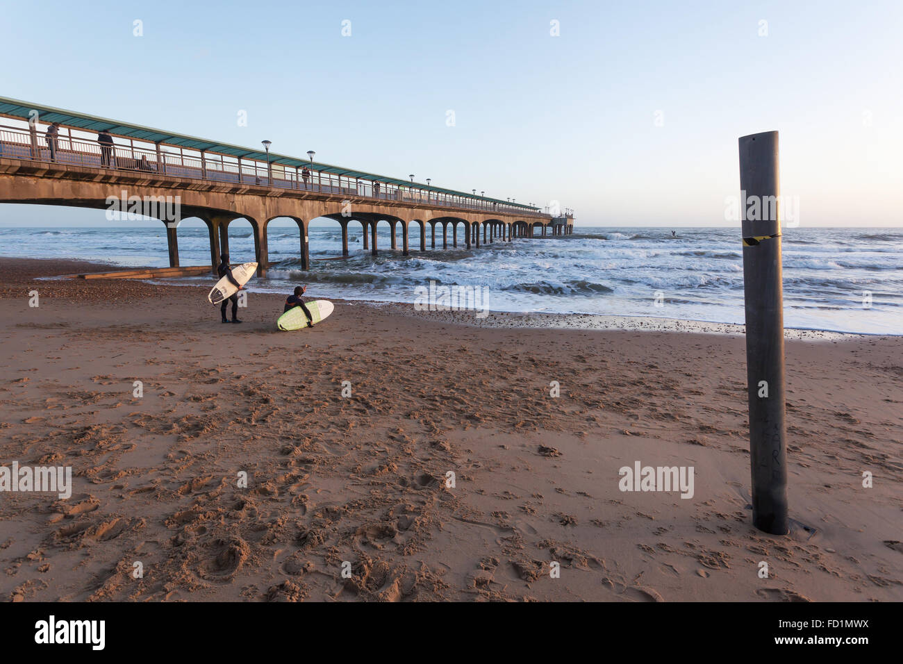 Two surfers under Boscombe Pier Stock Photo