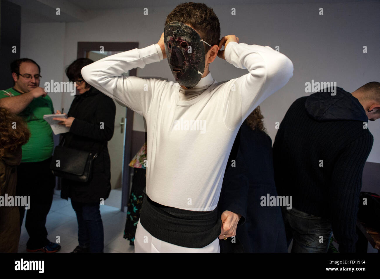 A young  putting on the mask of Mamuxarro for carnival Unanua in Navarra. Stock Photo