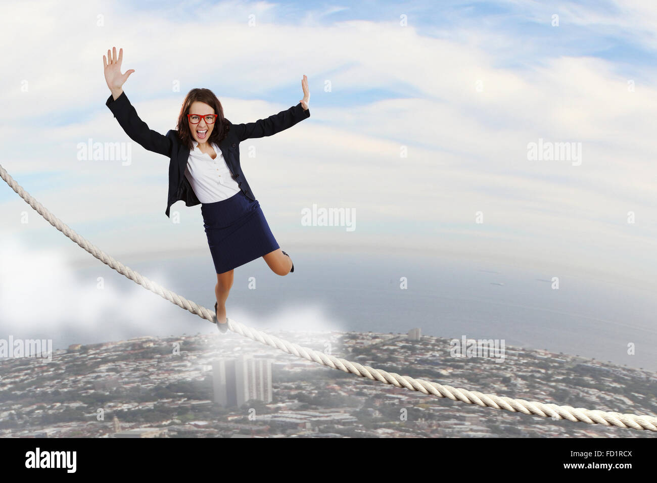Young attractive businesswoman balancing on rope high in sky Stock ...
