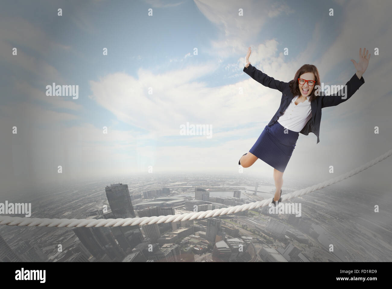 Young attractive businesswoman balancing on rope high in sky Stock ...