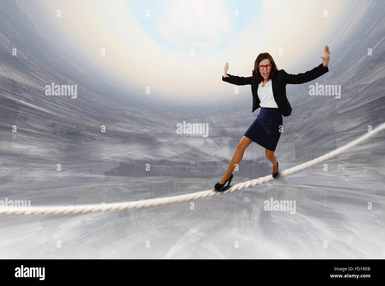 Young attractive businesswoman balancing on rope high in sky Stock ...