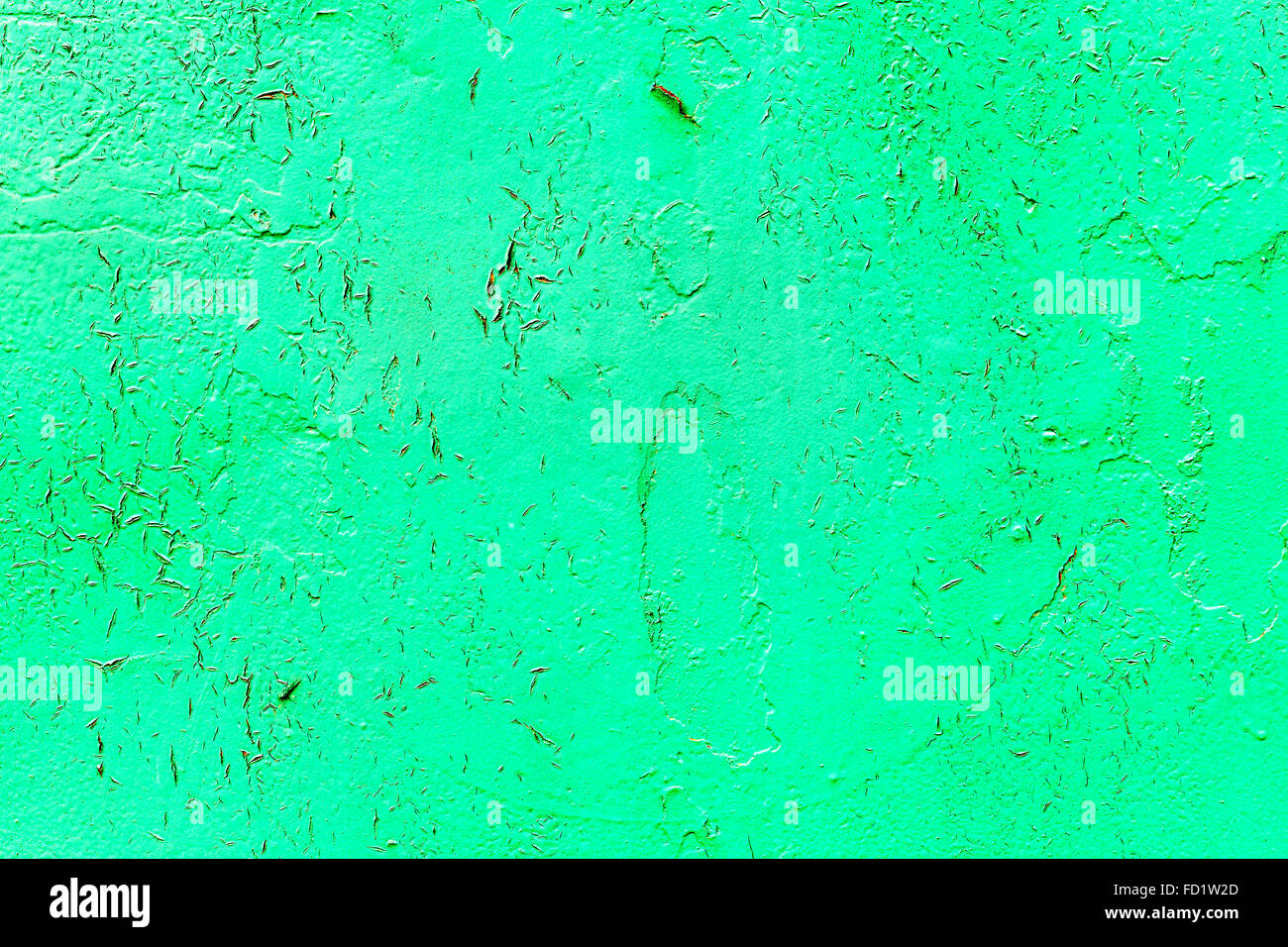 Vintage old damaged wall with cracks, scratches, painted with green paint. Textured background for your concept or project. Stock Photo