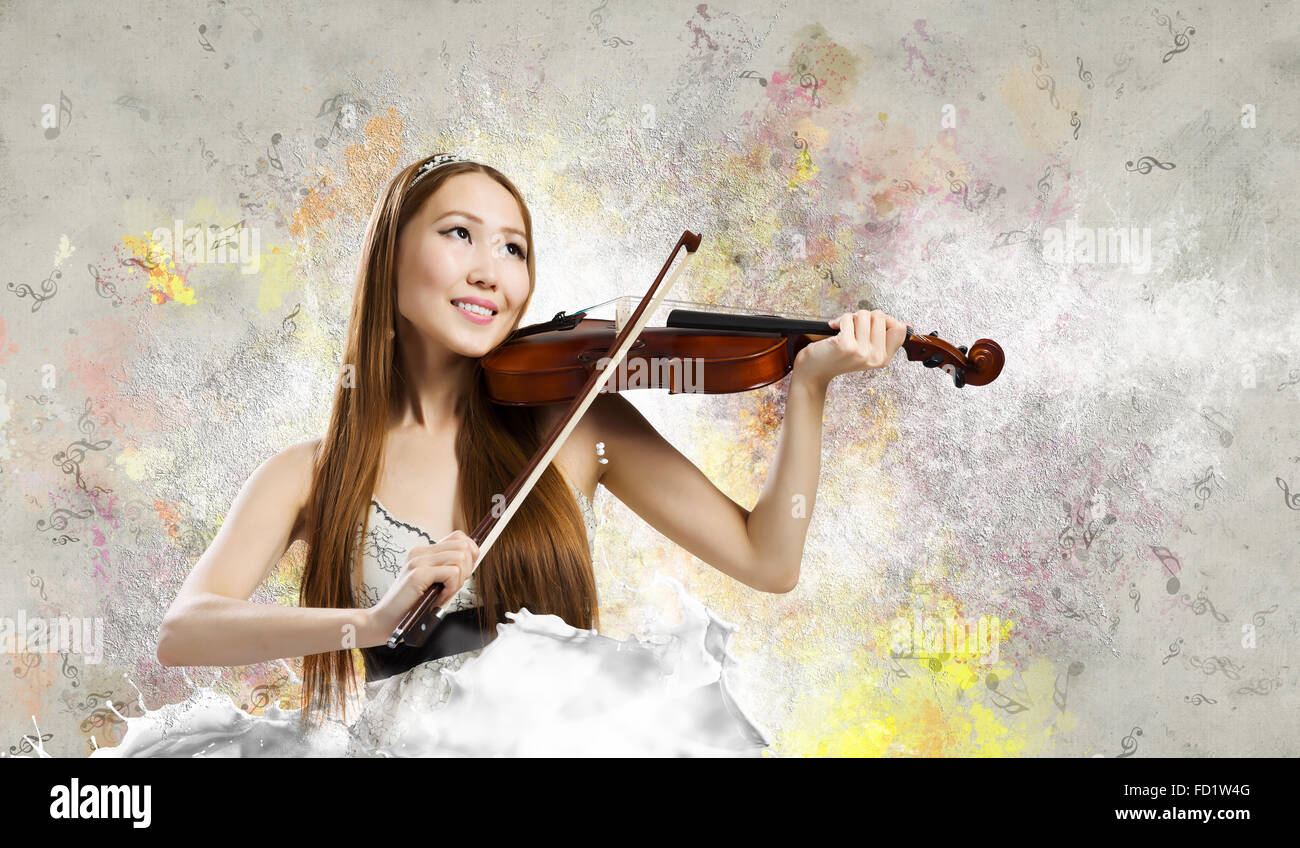 Young pretty asian woman playing violin. Young talent Stock Photo - Alamy