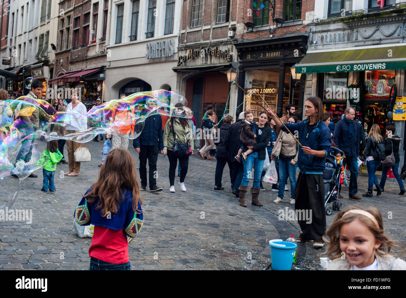 A street artist makes giant soap bubbles around Grand in Brussels Stock Photo