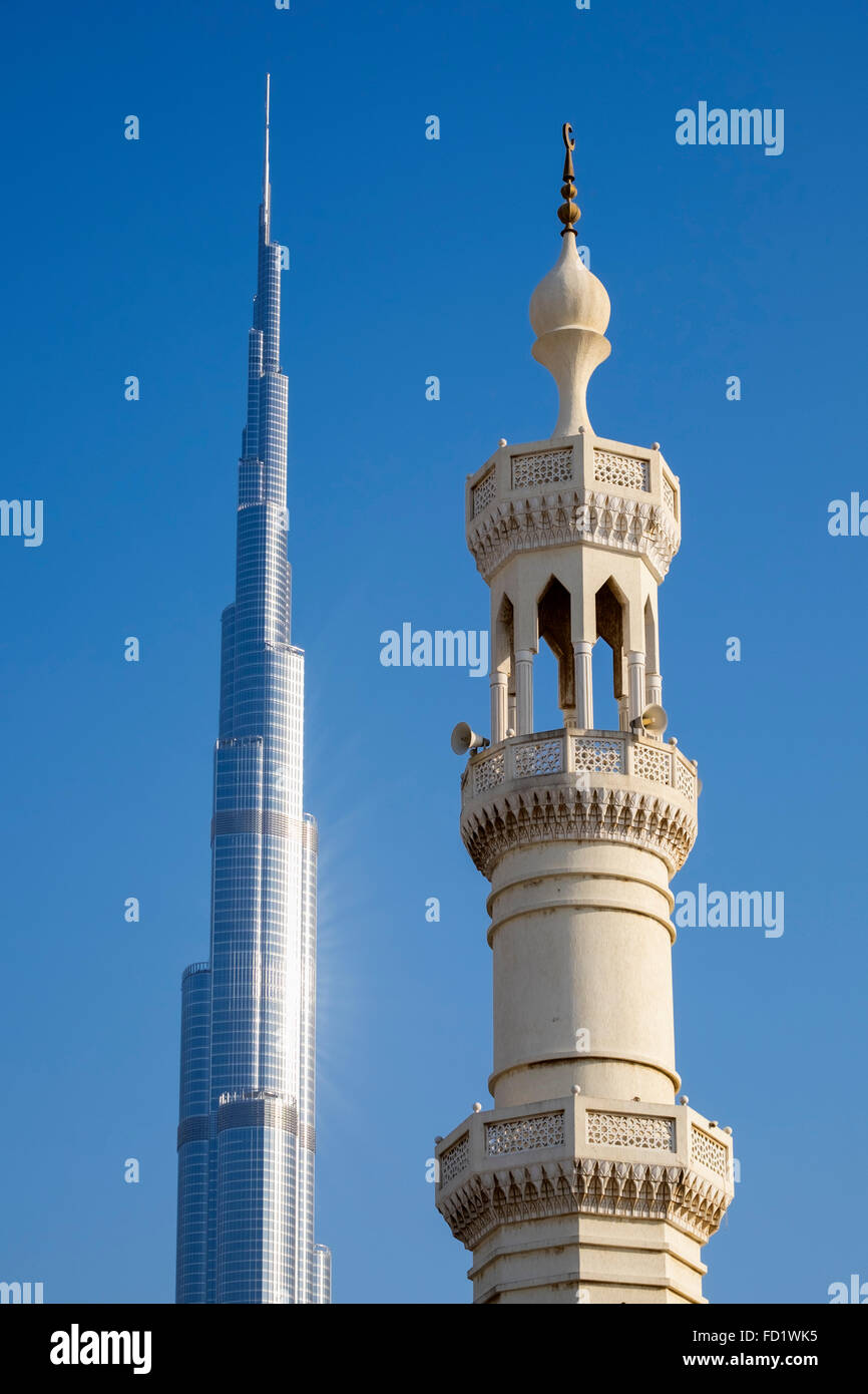Contrasting view of Burj Khalifa tower and mosque minaret in Dubai United Arab Emirates Stock Photo