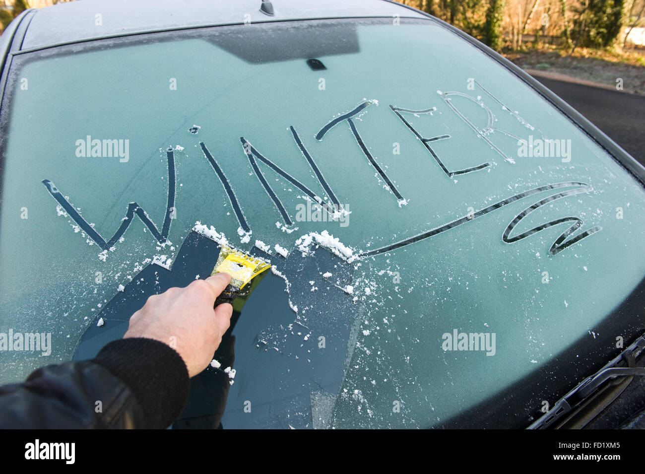 Removal ice from automobile windshield. Hand with liquid spray for car  window defrost in winter season Stock Photo - Alamy