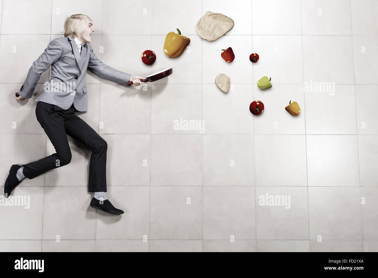 Young funny businessman running with pan in hand Stock Photo