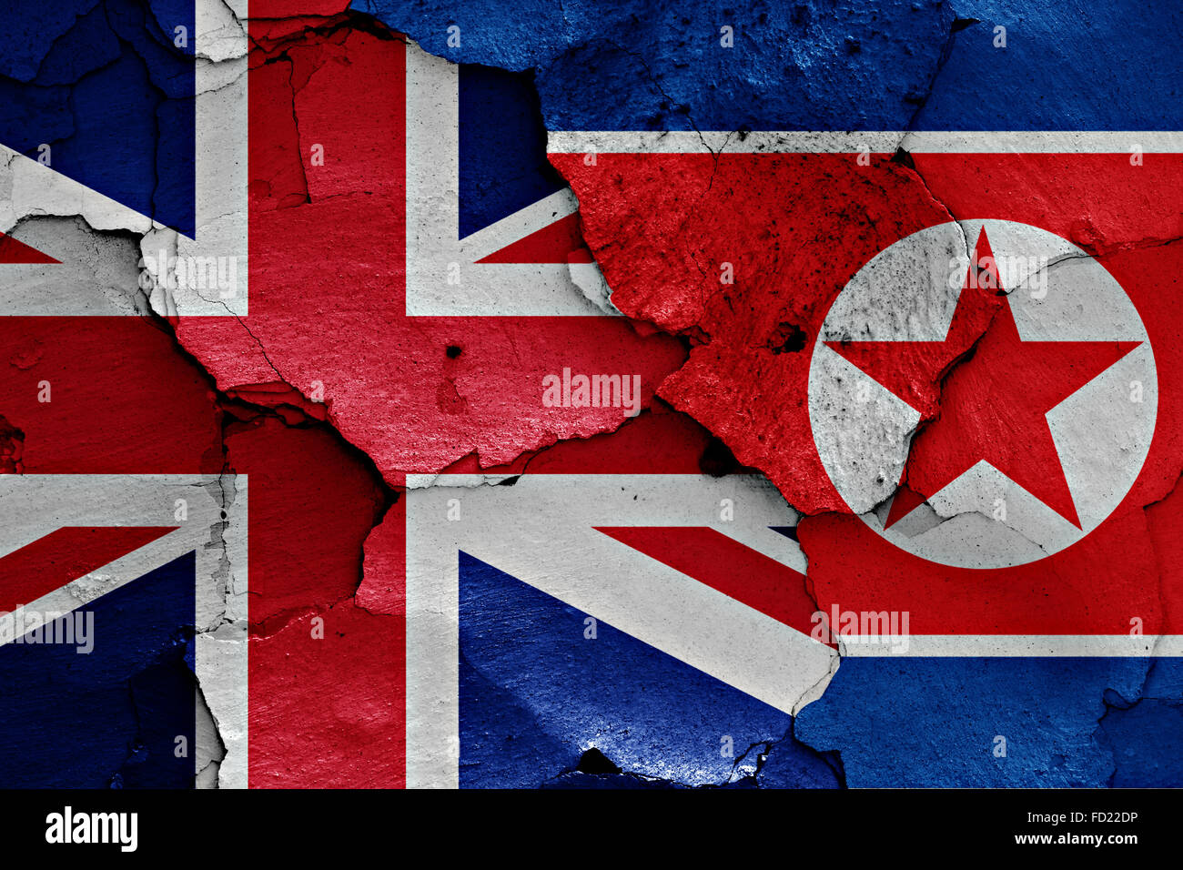 flags of UK and North Korea painted on cracked wall Stock Photo