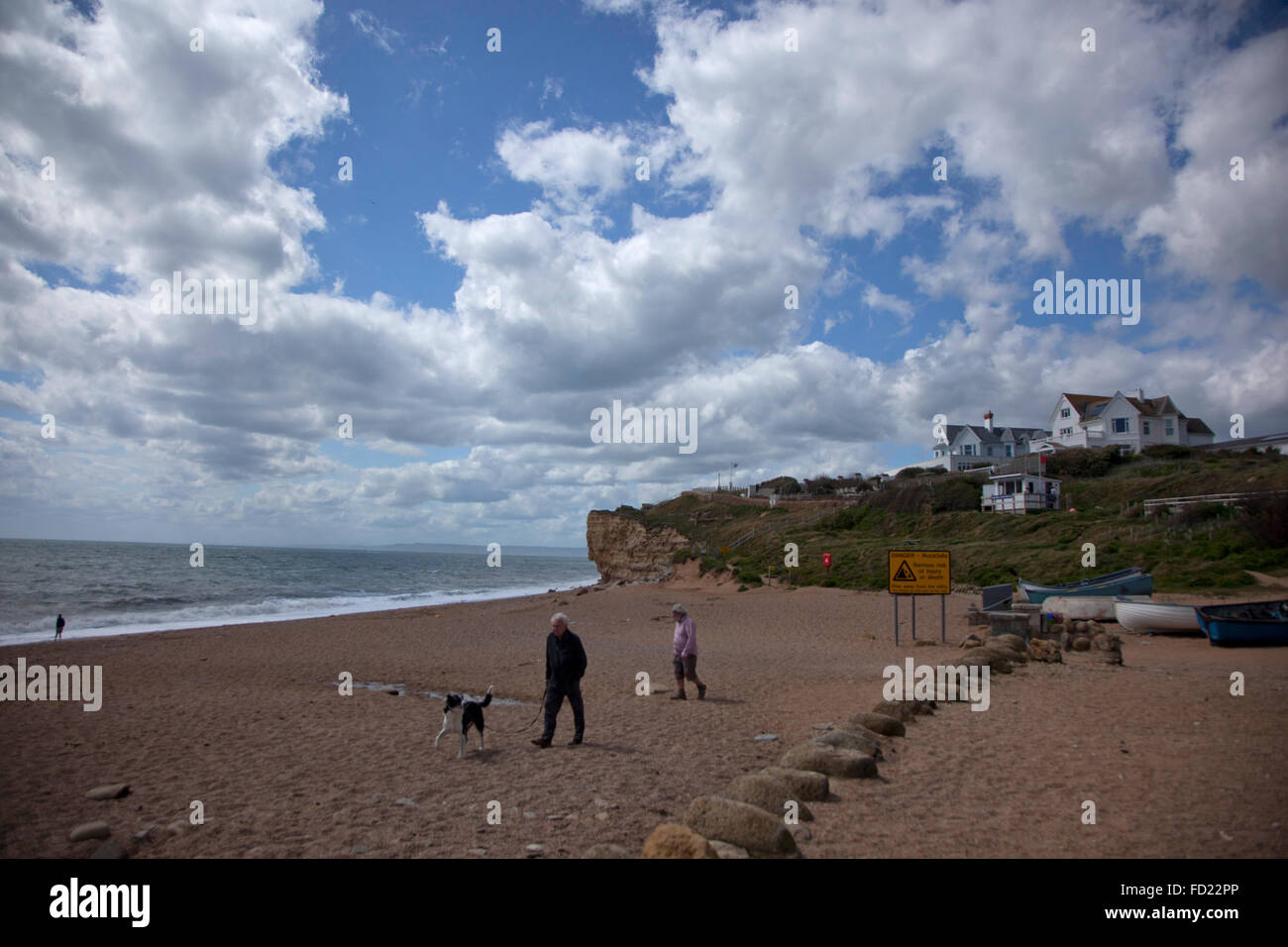 People and dog on beach, Burton Bradstock, Dorset Stock Photo