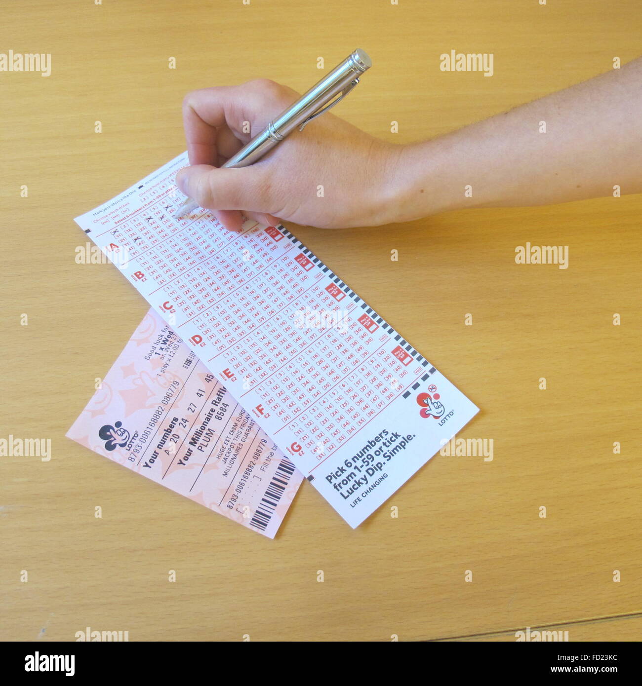 London, Great Britain. 27th Jan, 2016. A woman fills out a lottery ticket at a lottery retailer London, Great Britain. 27th Jan, 2016. A woman fills out a lottery ticket at a lottery retailer