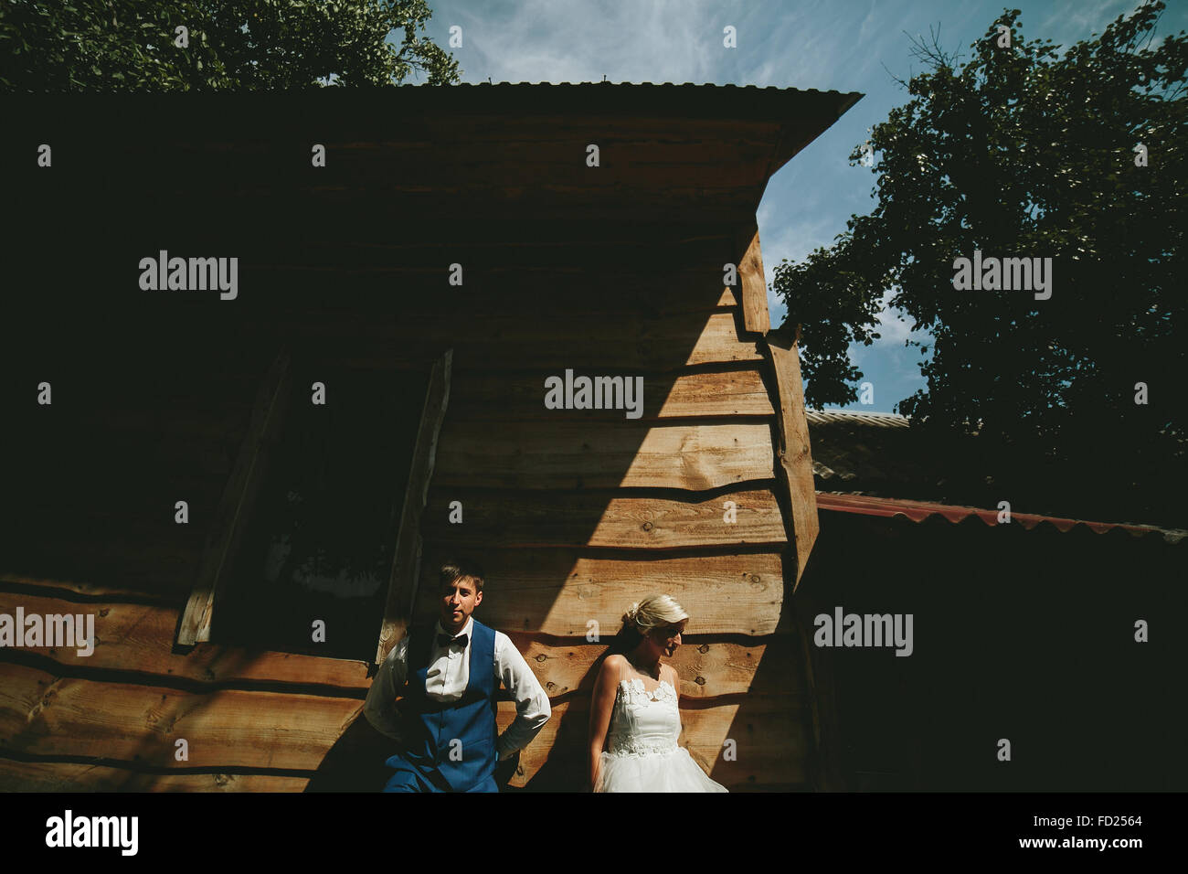 beautiful young wedding couple stands near house Stock Photo Alamy
