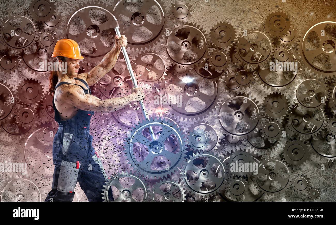 Strong man mechanic in uniform with spanner fixing mechanism Stock Photo -  Alamy